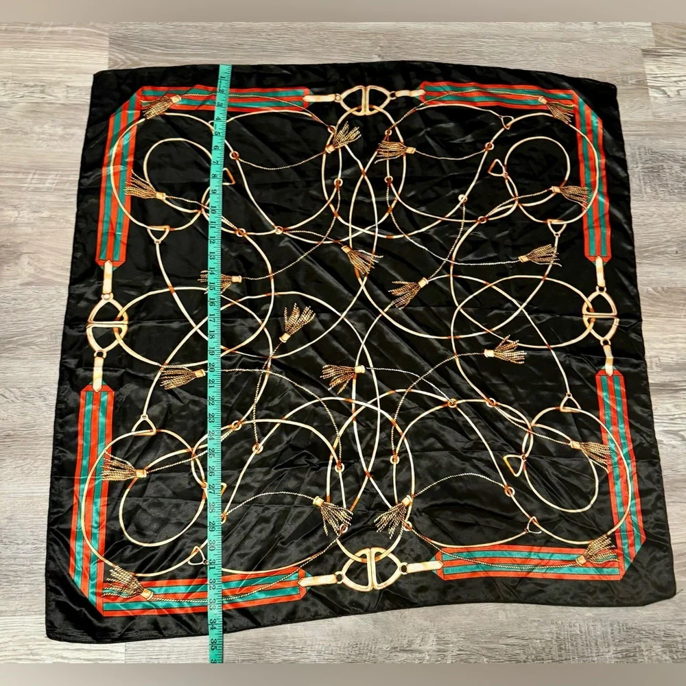 Fashionable women's black scarf with a chain and print. Polyester.